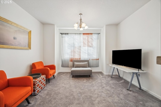 sitting room featuring an inviting chandelier and carpet floors