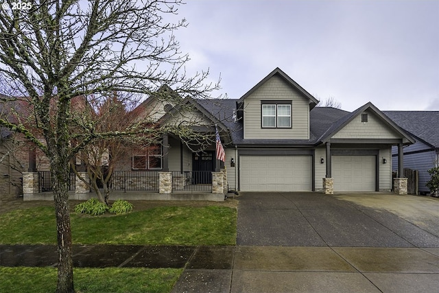 craftsman house featuring a garage, concrete driveway, a porch, and a front lawn