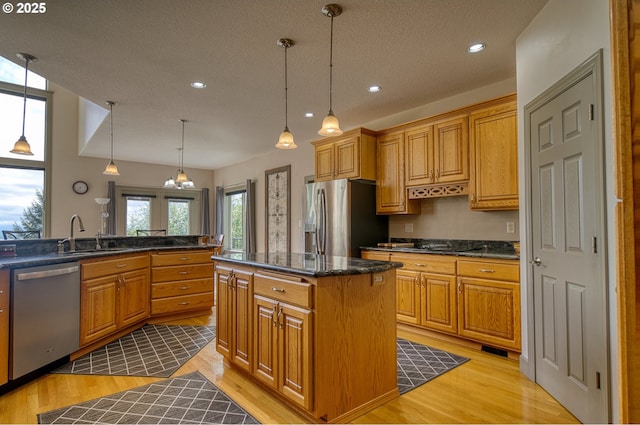 kitchen featuring recessed lighting, a sink, light wood-style flooring, and appliances with stainless steel finishes