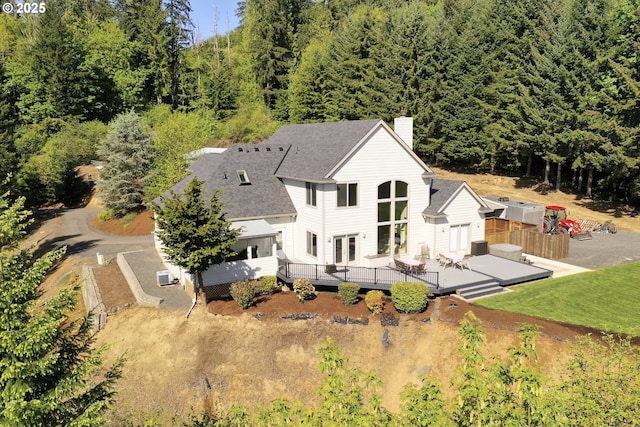 drone / aerial view featuring a wooded view