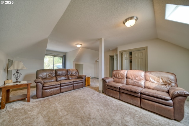 living area featuring a textured ceiling, vaulted ceiling, and carpet