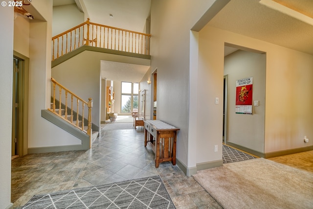 dining space featuring stone finish flooring, baseboards, a notable chandelier, and a raised ceiling
