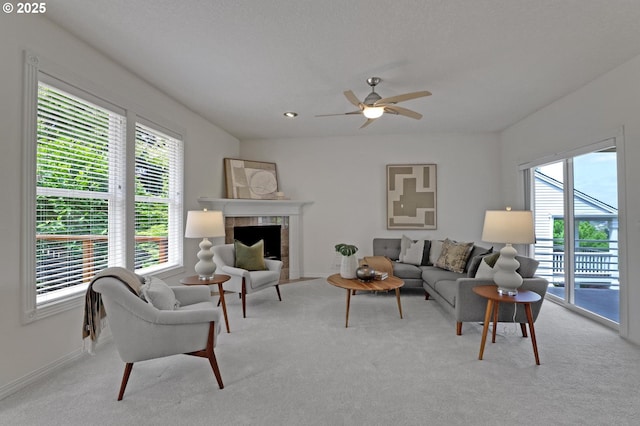 15017 SW Telluride Ter, Beaverton, OR 97007 - carpeted living area featuring healthy amount of natural light, ceiling fan, and a tiled fireplace