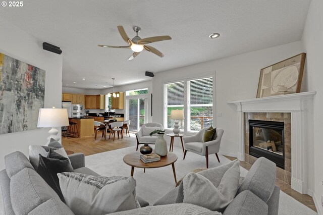 15017 SW Telluride Ter, Beaverton, OR 97007 - living area featuring ceiling fan, recessed lighting, a fireplace, and light wood-type flooring