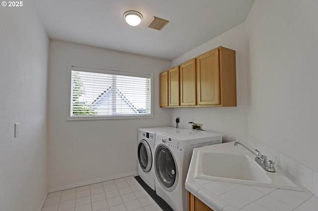 15017 SW Telluride Ter, Beaverton, OR 97007 - laundry room featuring washer and clothes dryer, cabinet space, and light tile patterned flooring