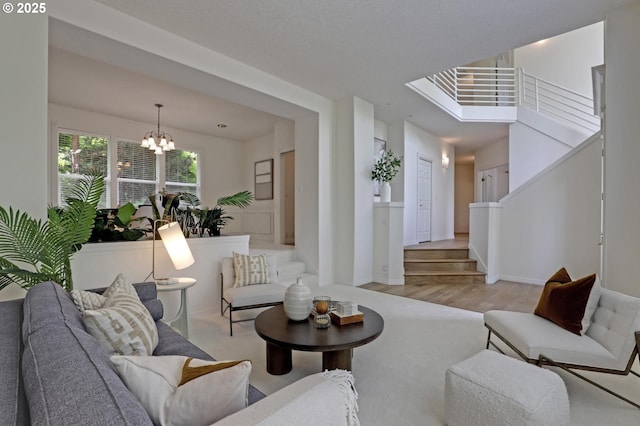 15017 SW Telluride Ter, Beaverton, OR 97007 - living room with a chandelier, wood finished floors, and stairway