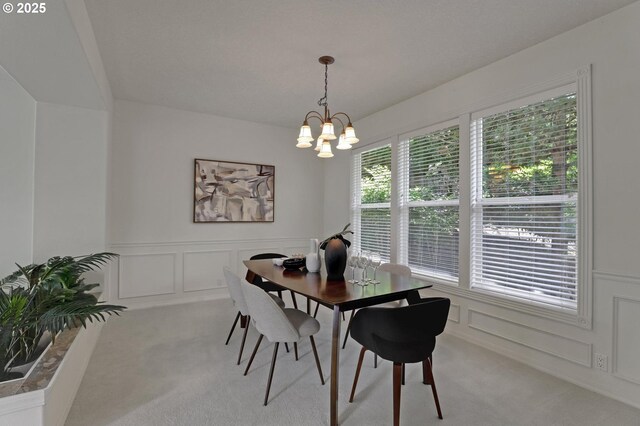 15017 SW Telluride Ter, Beaverton, OR 97007 - dining space with carpet, a decorative wall, a chandelier, and wainscoting