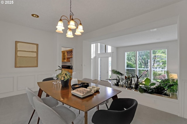 15017 SW Telluride Ter, Beaverton, OR 97007 - carpeted dining room featuring a chandelier and a sink