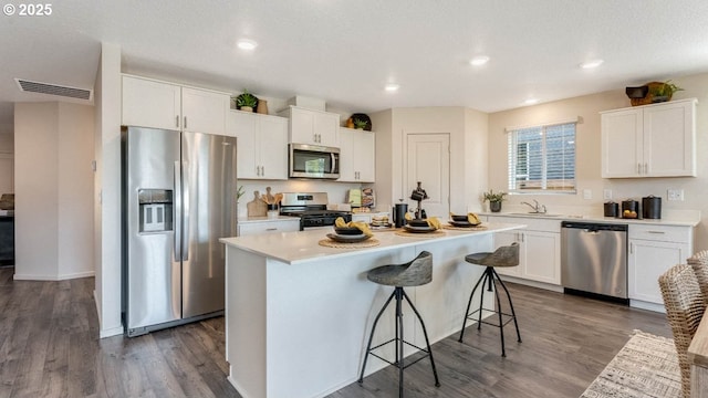 2906 U St, Springfield, OR 97477 - kitchen featuring stainless steel appliances, a sink, a kitchen breakfast bar, light countertops, and white cabinets
