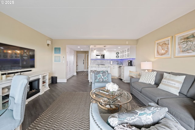 living room featuring dark wood finished floors and baseboards