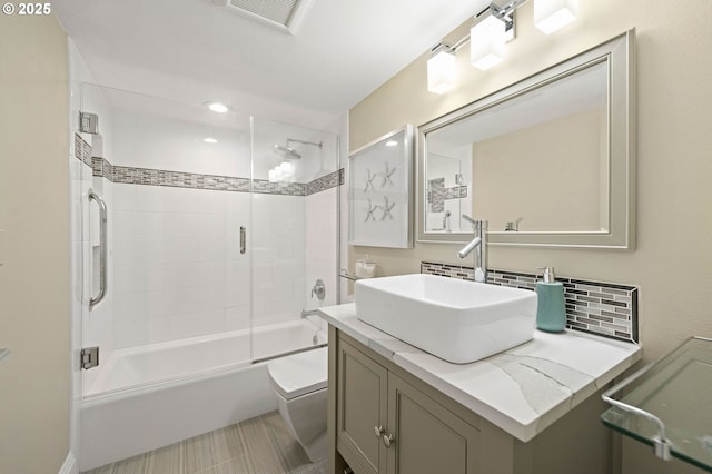 full bathroom with visible vents, decorative backsplash, toilet, enclosed tub / shower combo, and vanity