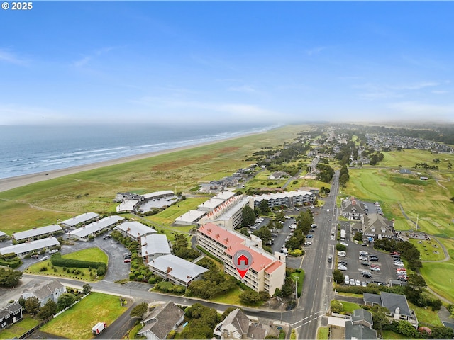 drone / aerial view featuring a view of the beach and a water view