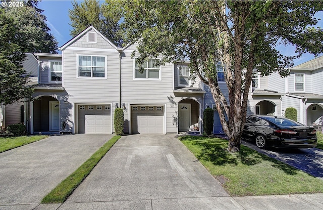 view of property with a garage and driveway