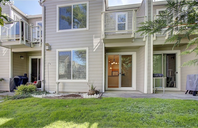 entrance to property with a lawn