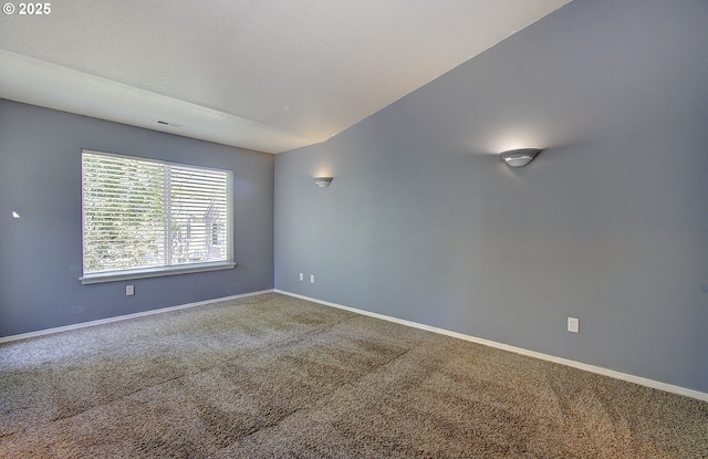 carpeted spare room featuring visible vents, baseboards, and a textured ceiling