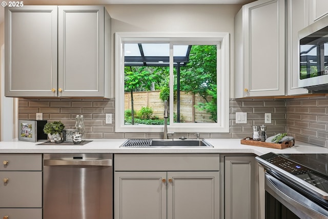 7330 SW Kelsi Ct, Portland, OR 97223 - kitchen featuring stainless steel appliances, a sink, light countertops, and tasteful backsplash
