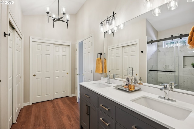 7330 SW Kelsi Ct, Portland, OR 97223 - full bathroom with a marble finish shower, wood finished floors, a closet, and double vanity