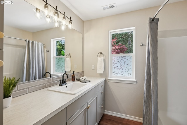 7330 SW Kelsi Ct, Portland, OR 97223 - full bath with vanity, a shower with curtain, wood finished floors, and baseboards