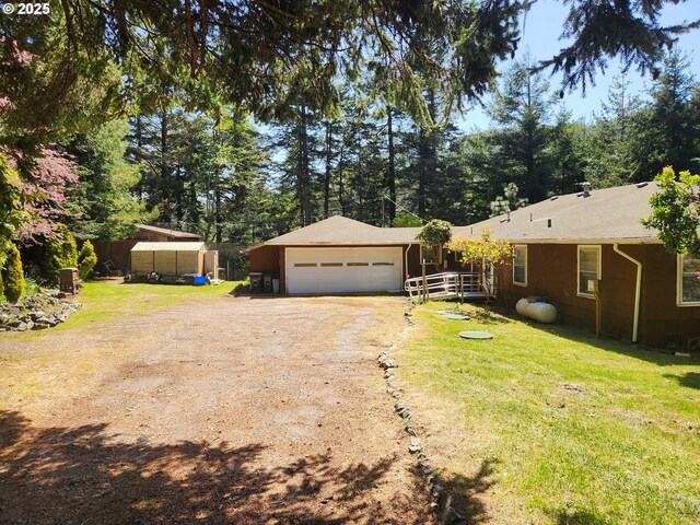 28213 Hunter Creek Hts, Gold Beach, OR 97444 - view of front of house with driveway, fence, a garage, and a front yard