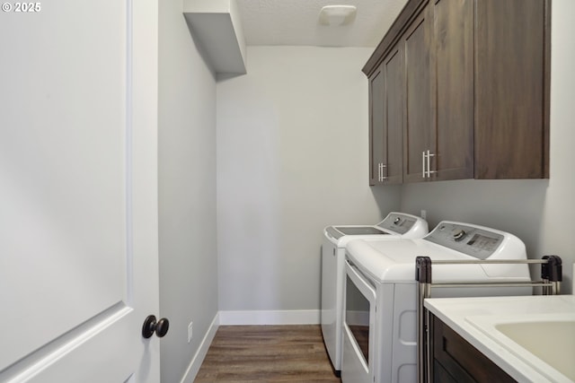 1522 NE Sunrise Ln, Hillsboro, OR 97124 - laundry area with baseboards, cabinet space, independent washer and dryer, and dark wood-style flooring