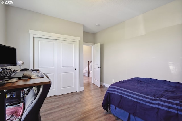 1522 NE Sunrise Ln, Hillsboro, OR 97124 - bedroom featuring baseboards, a closet, and wood finished floors