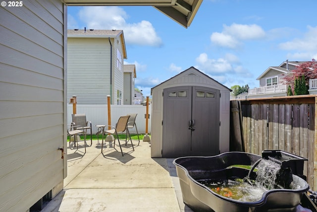 1522 NE Sunrise Ln, Hillsboro, OR 97124 - view of patio with an outdoor structure, a shed, and a fenced backyard