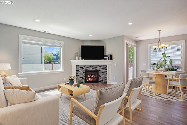 1522 NE Sunrise Ln, Hillsboro, OR 97124 - living area with visible vents, a tiled fireplace, wood finished floors, a notable chandelier, and recessed lighting