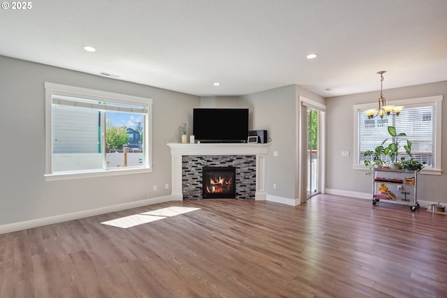 1522 NE Sunrise Ln, Hillsboro, OR 97124 - unfurnished living room featuring wood finished floors, baseboards, recessed lighting, a chandelier, and a tiled fireplace