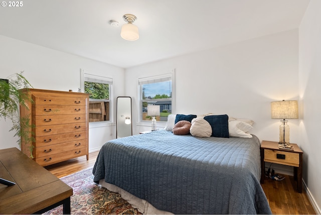 bedroom featuring light wood-type flooring and baseboards