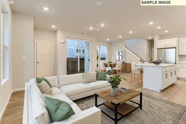 living room featuring light wood-style floors, recessed lighting, and baseboards