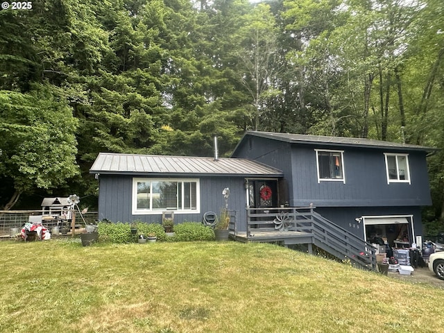 585 Robinhood Ave, Lakeside, OR 97449 - split level home featuring a front yard, a metal roof, and an attached garage