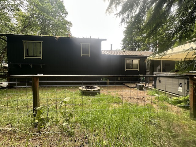 585 Robinhood Ave, Lakeside, OR 97449 - rear view of house with a metal roof and a fire pit