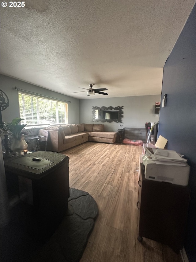 585 Robinhood Ave, Lakeside, OR 97449 - living area featuring a textured ceiling, ceiling fan, and wood finished floors