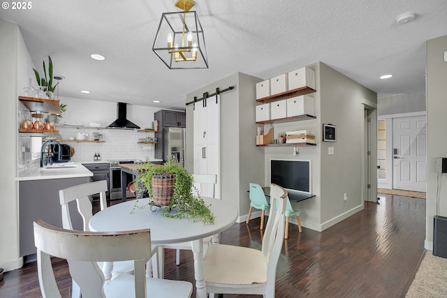 2805 Knox Ridge Ter, Forest Grove, OR 97116 - dining room featuring a barn door, dark wood finished floors, recessed lighting, a chandelier, and a textured ceiling