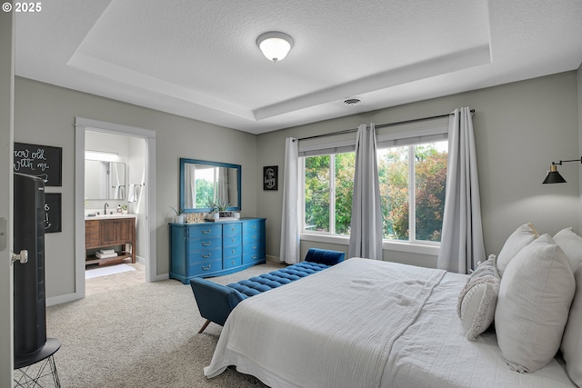 2805 Knox Ridge Ter, Forest Grove, OR 97116 - carpeted bedroom featuring a tray ceiling, multiple windows, a textured ceiling, and connected bathroom