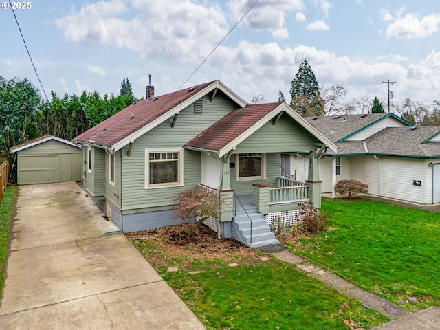 bungalow-style house with covered porch, a front yard, and a storage shed