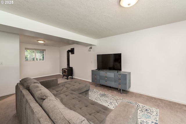 carpeted living area featuring a wood stove, baseboards, and a textured ceiling