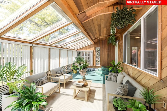 sunroom / solarium with vaulted ceiling with skylight and a wealth of natural light