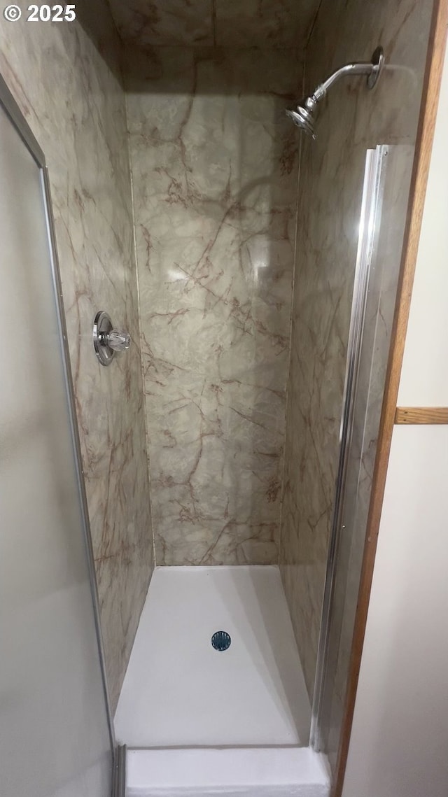 full bath featuring a shower stall