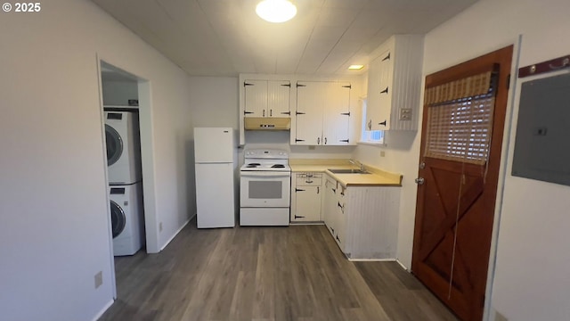 kitchen with stacked washer / drying machine, white cabinetry, a sink, white appliances, and under cabinet range hood