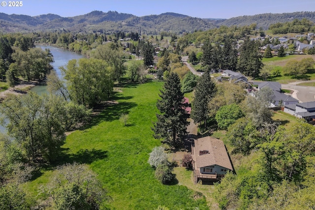 bird's eye view with a water and mountain view and a forest view