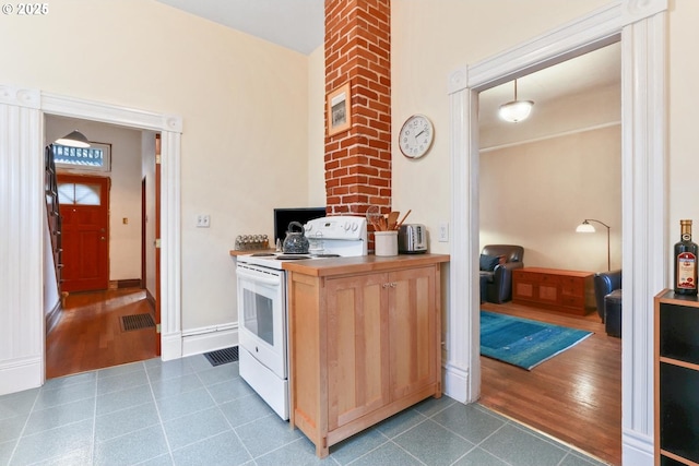 kitchen featuring dark tile patterned flooring and white range with electric stovetop