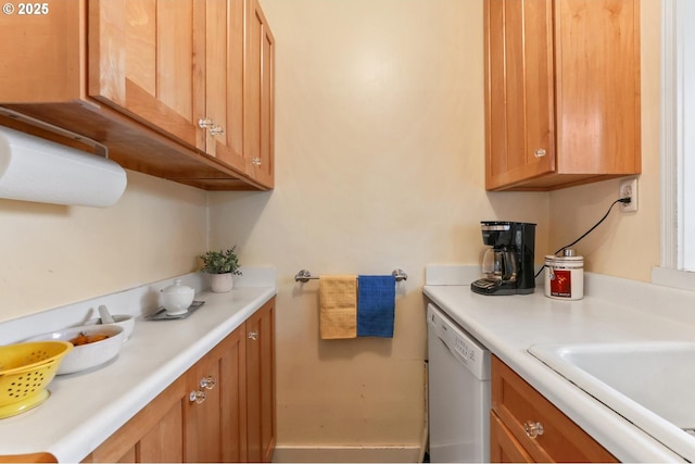 kitchen featuring white dishwasher and sink