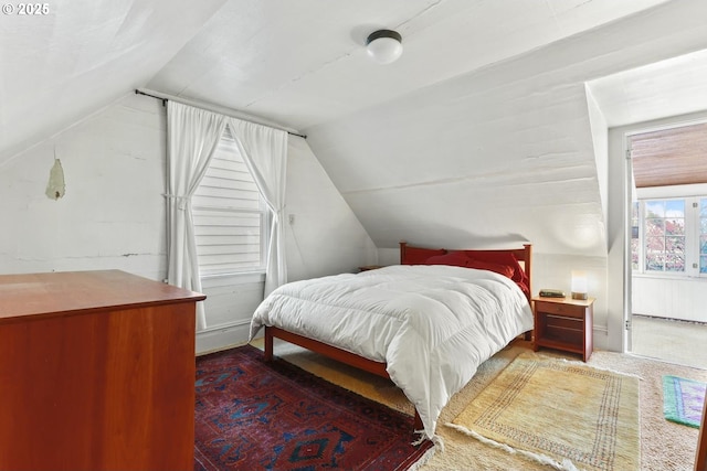 carpeted bedroom featuring lofted ceiling