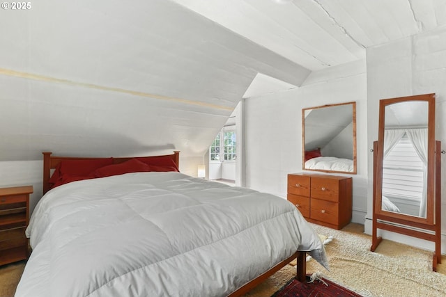 carpeted bedroom with vaulted ceiling