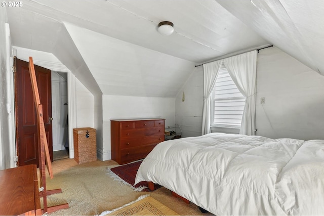 bedroom featuring vaulted ceiling and carpet