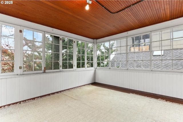 unfurnished sunroom with wooden ceiling