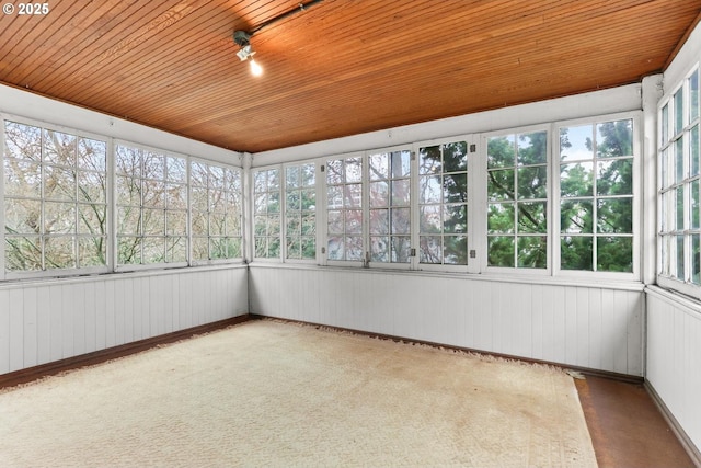 unfurnished sunroom with wooden ceiling