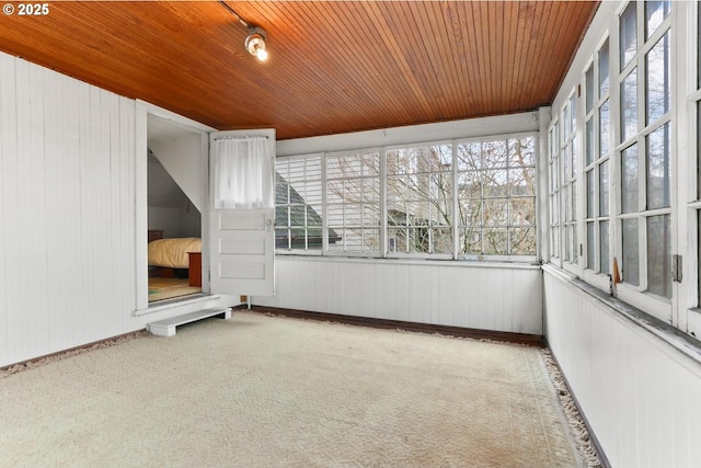 unfurnished sunroom with wooden ceiling