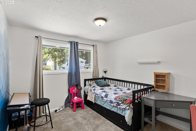 bedroom with carpet and a textured ceiling
